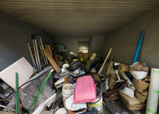 An overflowing container filled with a large assortment of junk, featuring a mix of debris and unwanted items